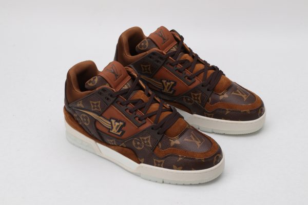 A pair of brown and tan monogrammed low-top sneakers with darker brown accents
