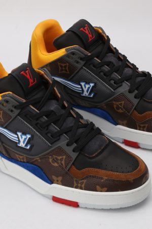 A pair of multi-toned low-top sneakers featuring brown and black monogrammed sections