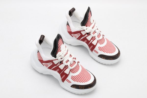 A single white chunky athletic sneaker with iridescent pink and silver overlays