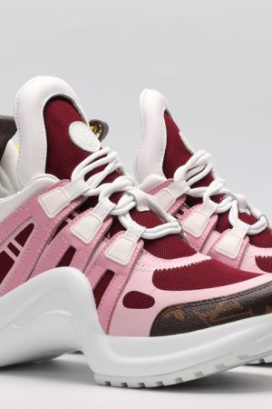 A pair of white chunky athletic sneakers with light pink and burgundy overlays